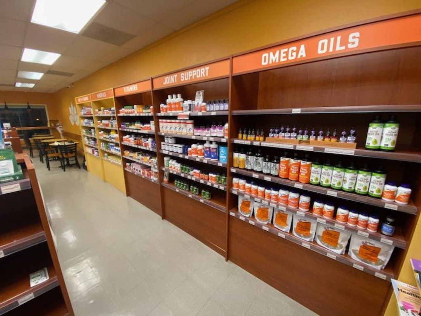 A row of shelves filled with omega oils in a store