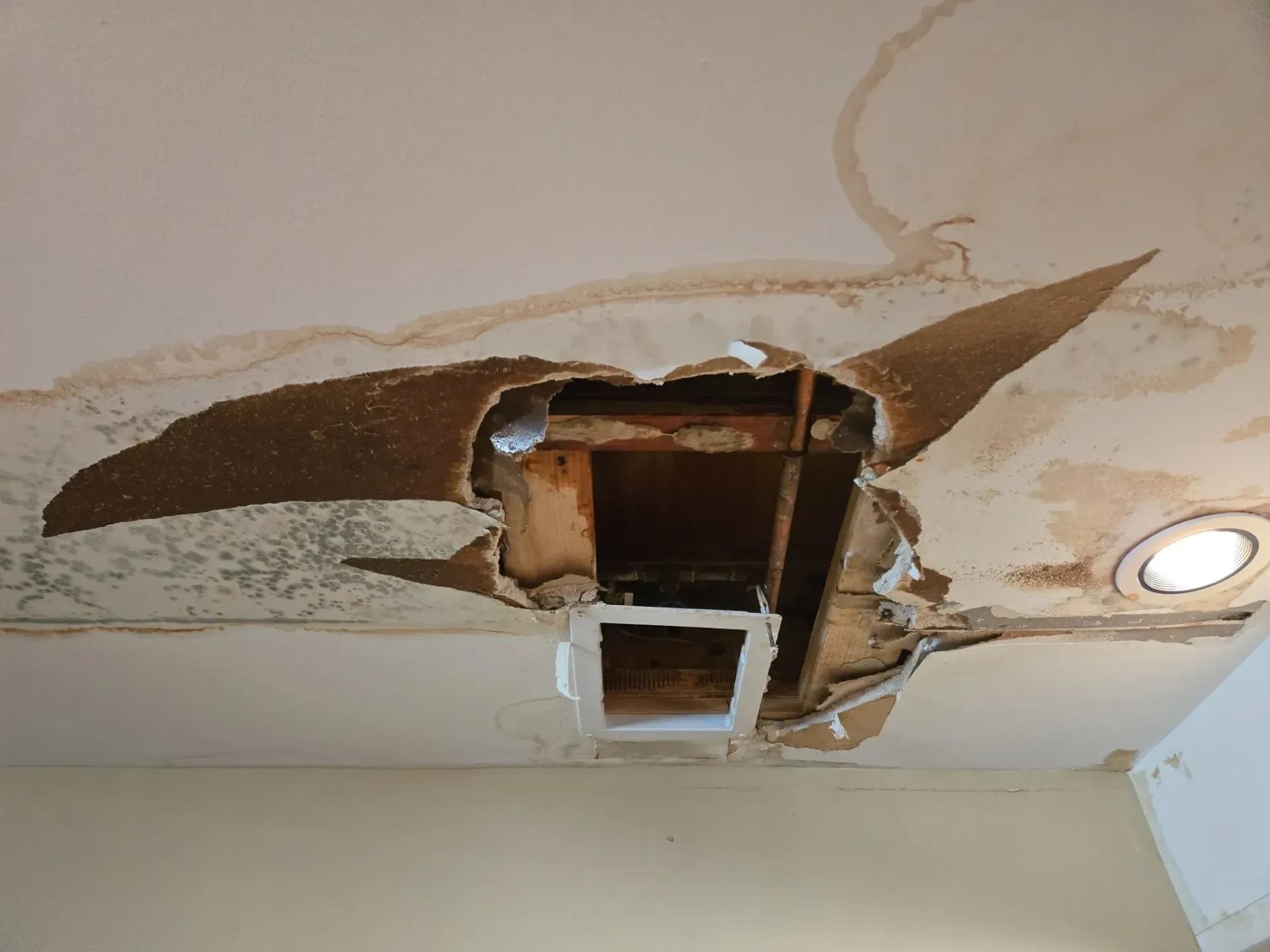 Air conditioning units with toolbox and gloves in backyard.