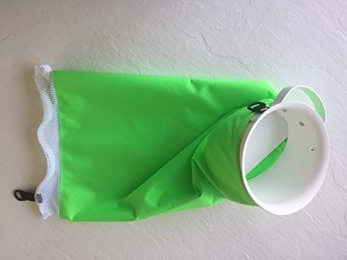 Green dry bag with white opening and mesh detail, lying on a white surface.