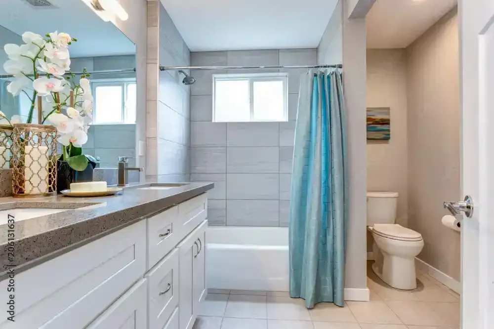 A plumber is fixing a water meter on a pipe.