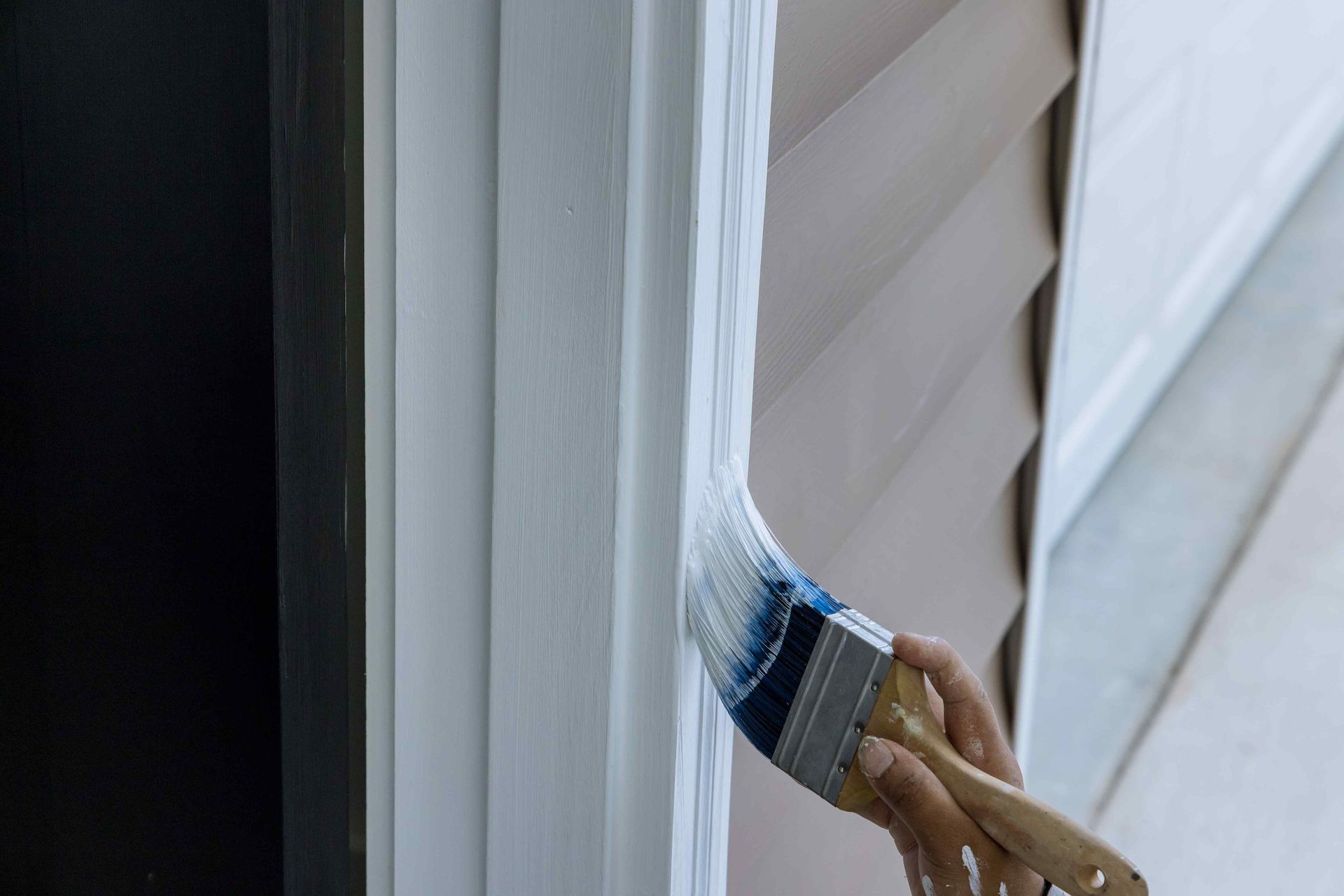 A person is painting a door with a brush.