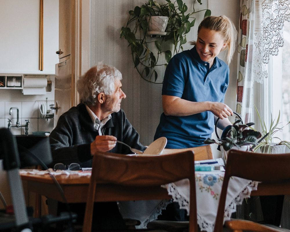 Nurse is Feeding an Elderly Man – Middlebury, IN – New Outlook Home Care of Northern IN LLC