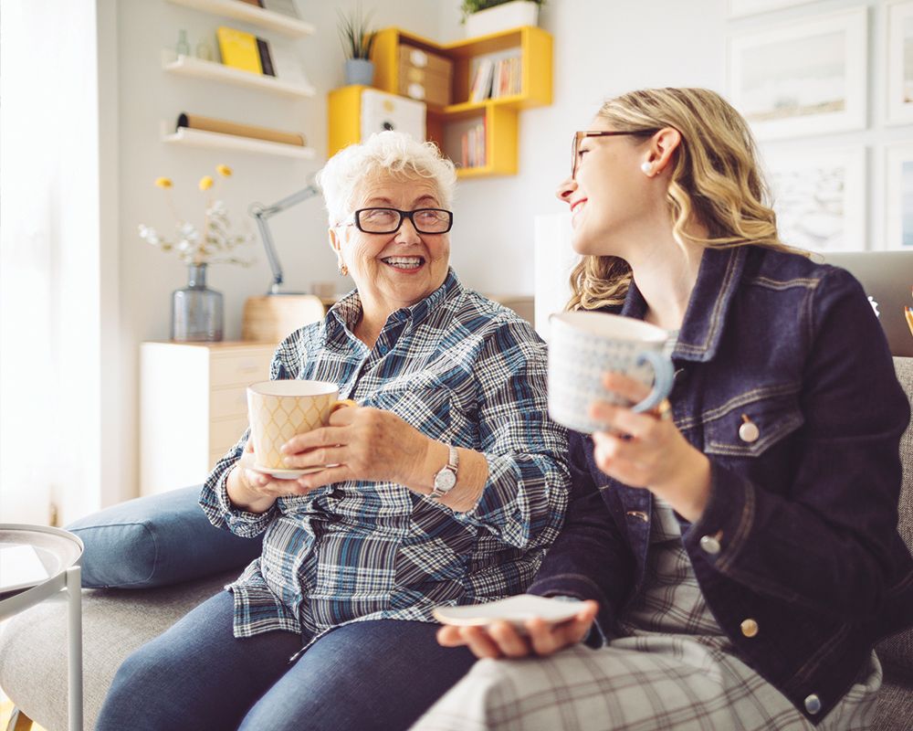 Two Women are Sitting on a Couch – Middlebury, IN – New Outlook Home Care of Northern IN LLC