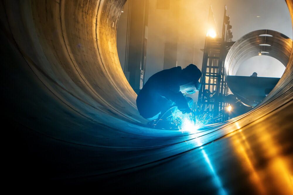 Welder Inside a Large Metal Cylinder — Townsville Stainless Steel in Weipa, QLD