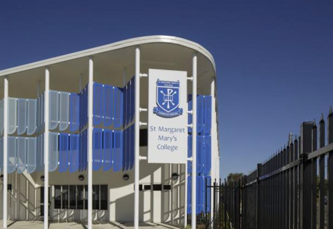 St. Margaret Mary's College entrance with blue and white facade under a clear blue sky — Townsville Stainless Steel in Garbutt, QLD