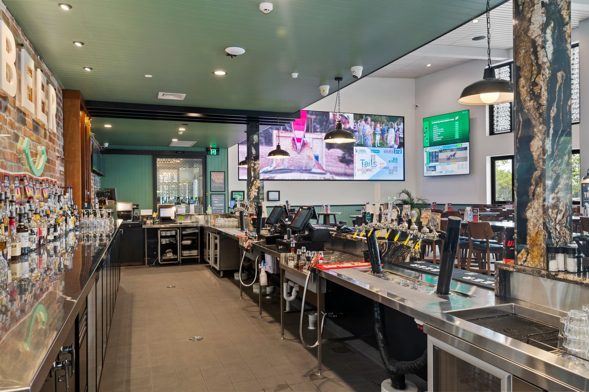 Interior Bar With a White and Tiled Front, Stocked With Liquor Bottles — Townsville Stainless Steel in Garbutt, QLD