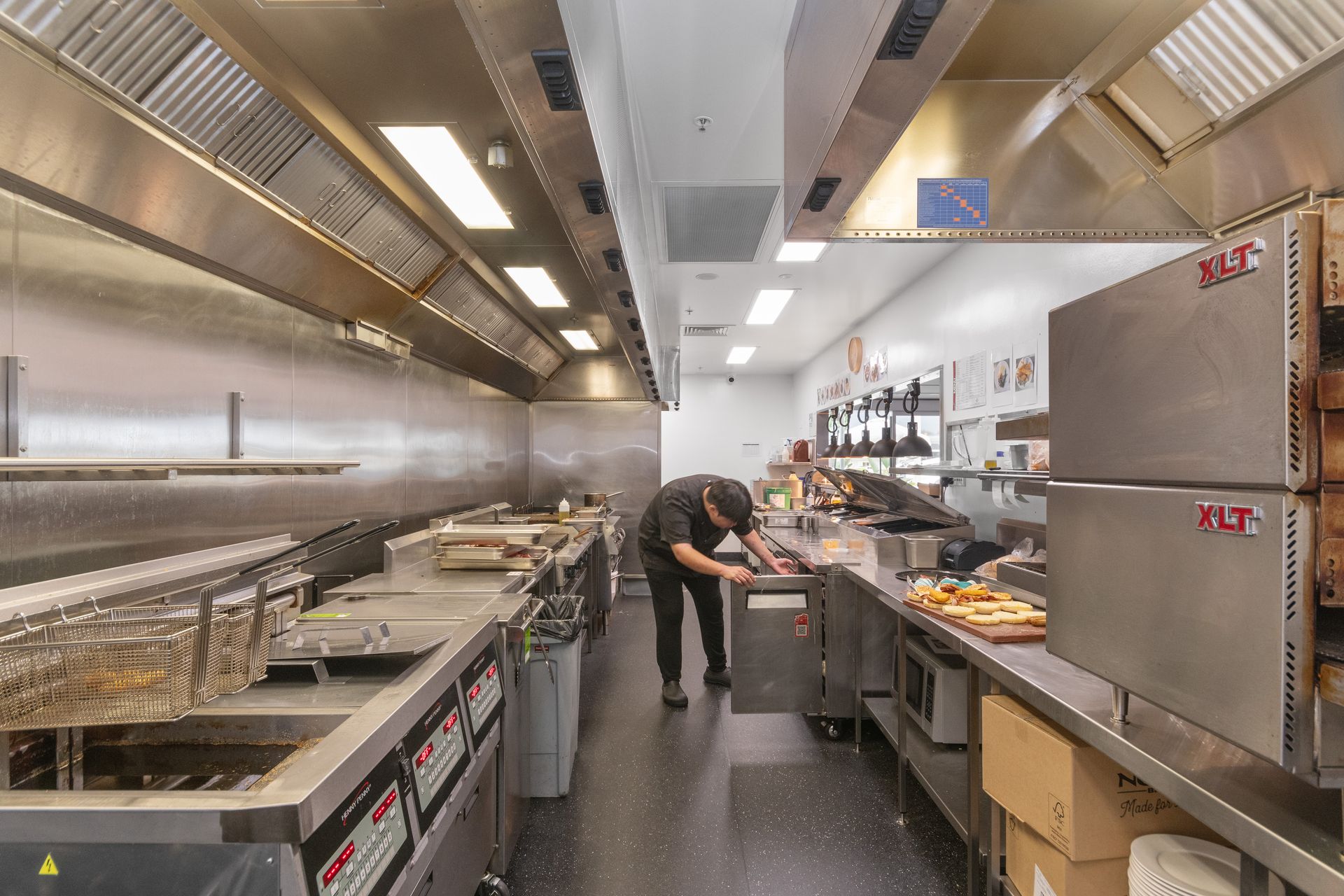 A Large Kitchen with Stainless Steel Appliances and Counter Tops — Townsville Stainless Steel in Garbutt, QLD