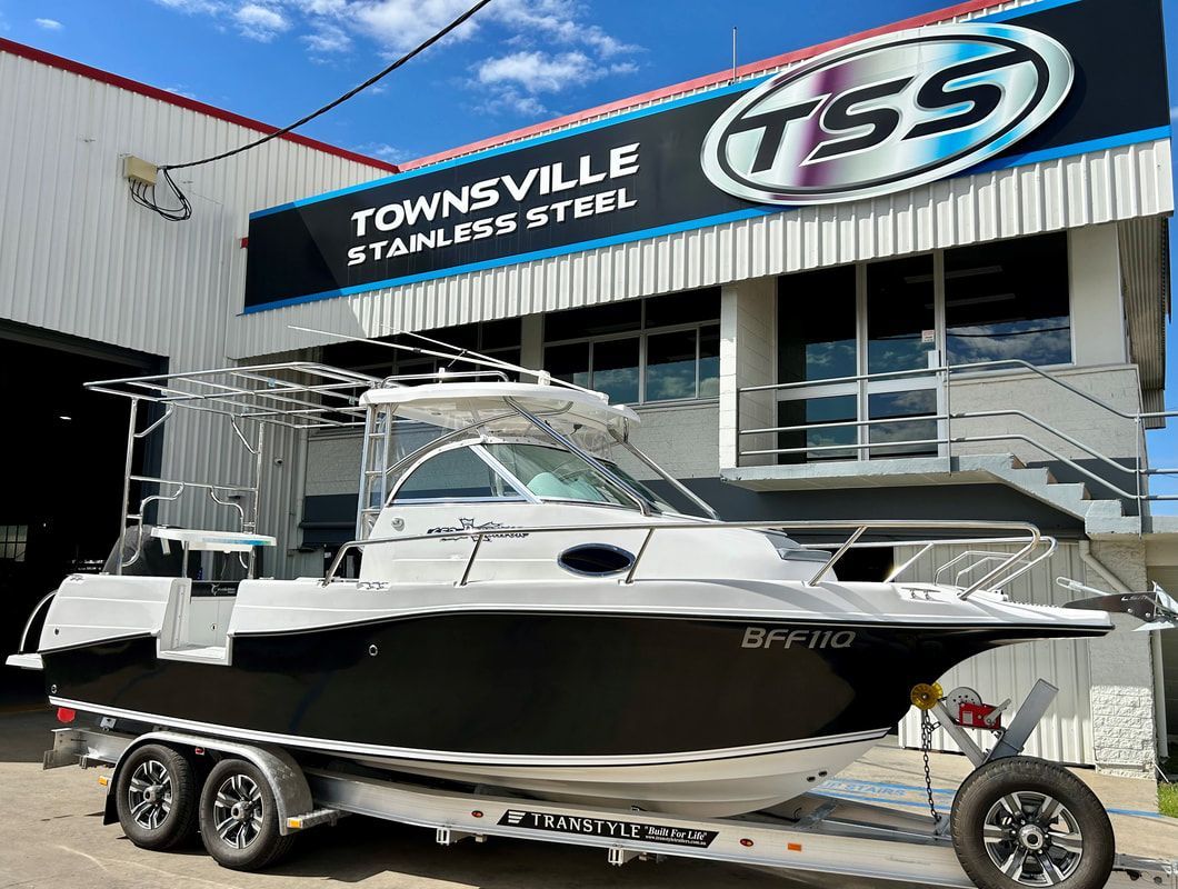 A Boat Is Parked on A Trailer in Front of A Building — Townsville Stainless Steel in Garbutt, QLD