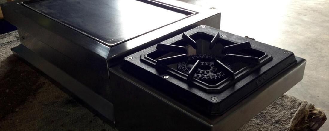 A Stove Top Oven Is Sitting on Top of A Carpeted Floor — Townsville Stainless Steel in Garbutt, QLD