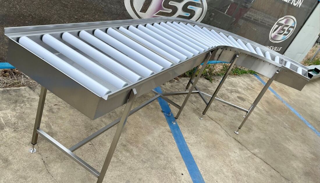 A Stainless Steel Conveyor Belt Is Sitting on Top of A Metal Table — Townsville Stainless Steel in Garbutt, QLD