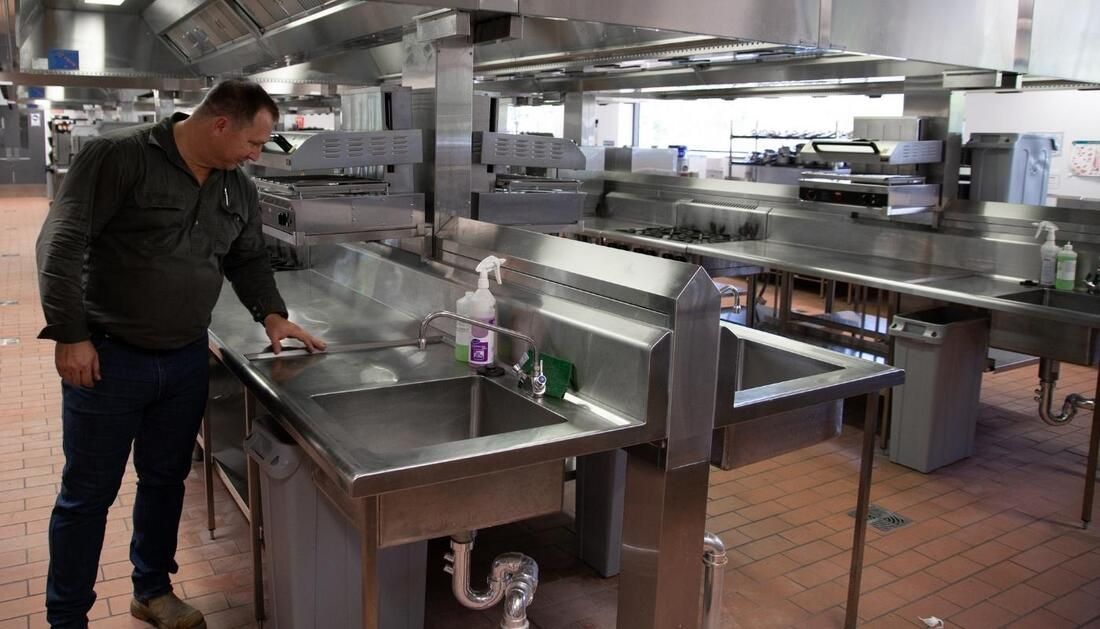 Man Beside Steel Kitchen Sink — Townsville Stainless Steel in Garbutt, QLD