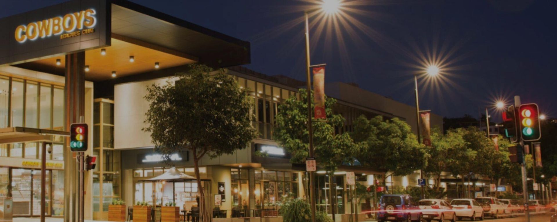 A Building with The Word Cowboys on It Is Lit up At Night — Townsville Stainless Steel in Garbutt, QLD