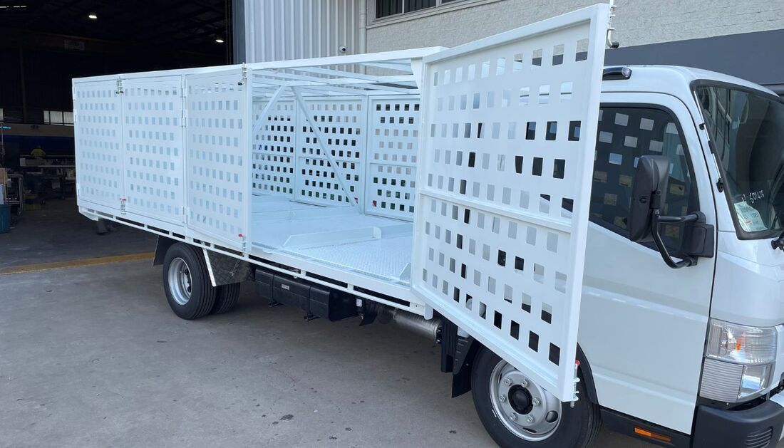 A White Truck with A Cage on The Back Is Parked in Front of A Building — Townsville Stainless Steel in Garbutt, QLD
