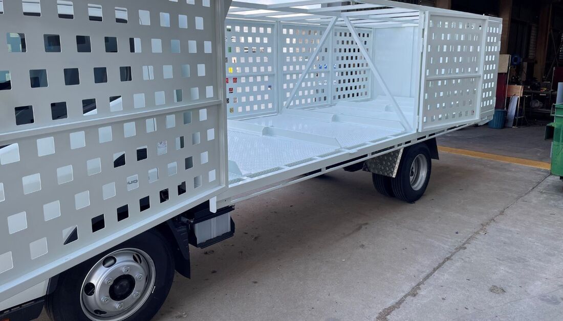 A Truck with A Cage on The Side of It Is Parked in A Parking Lot — Townsville Stainless Steel in Garbutt, QLD