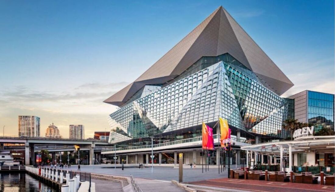 A Large Building with A Pyramid Shaped Roof Is Sitting Next to A Body of Water — Townsville Stainless Steel in Garbutt, QLD