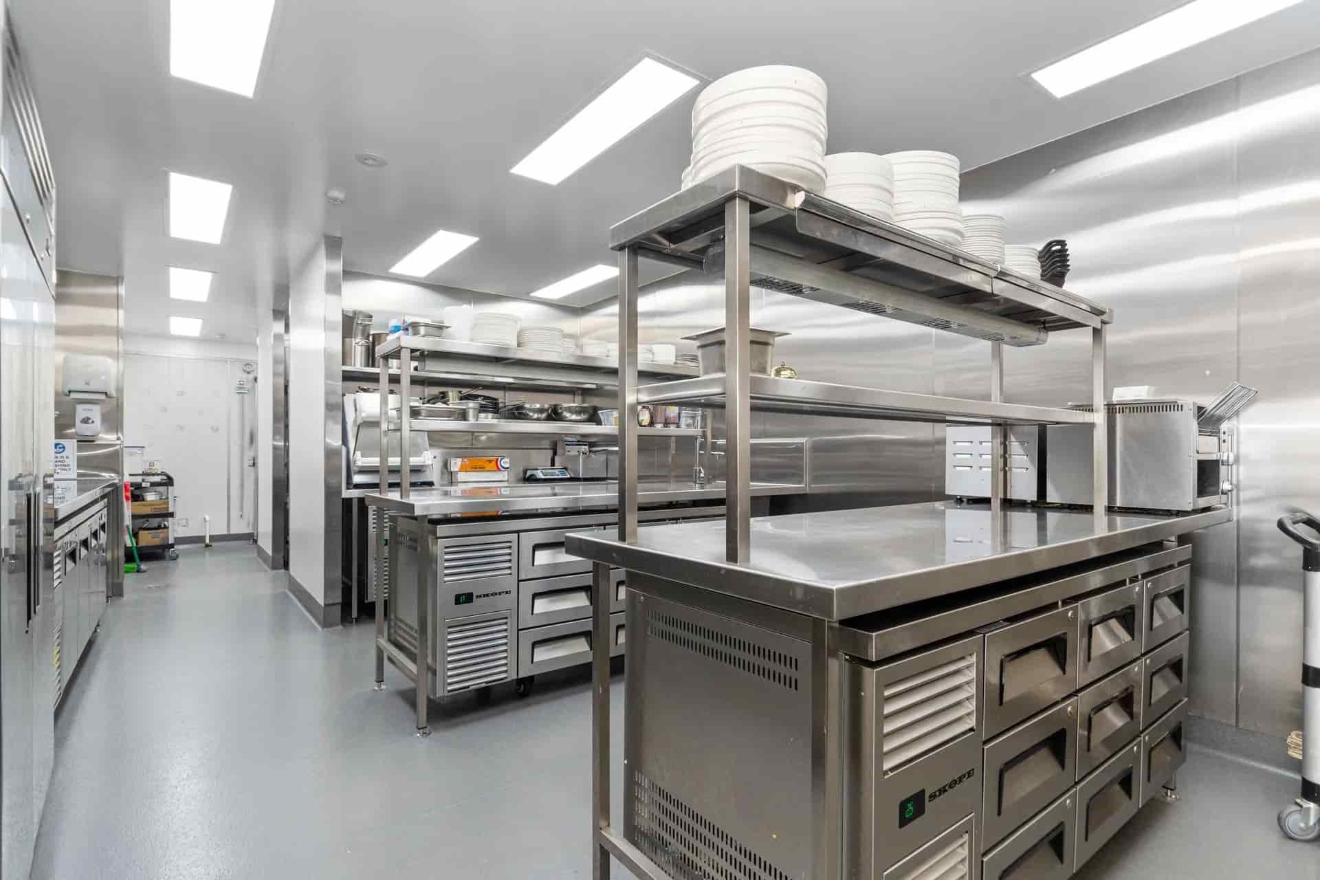 An Industrial Kitchen With Stainless Steel Counters, Shelves — Townsville Stainless Steel in Garbutt, QLD