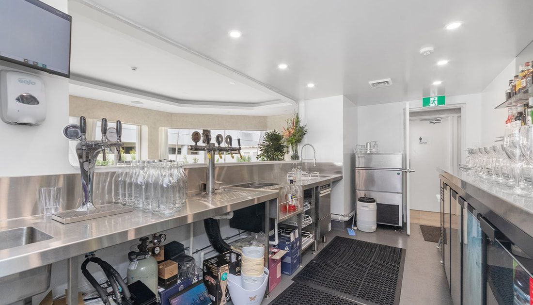 A Kitchen with A Lot of Glasses on The Counter and A Refrigerator — Townsville Stainless Steel in Garbutt, QLD