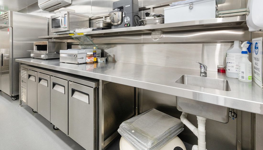 A Kitchen with Stainless Steel Appliances and A Sink — Townsville Stainless Steel in Garbutt, QLD