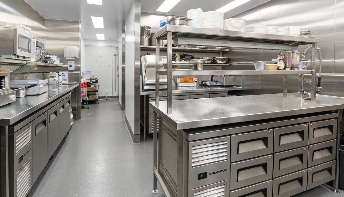 A Kitchen with A Lot of Stainless Steel Appliances and Counter Tops — Townsville Stainless Steel in Garbutt, QLD