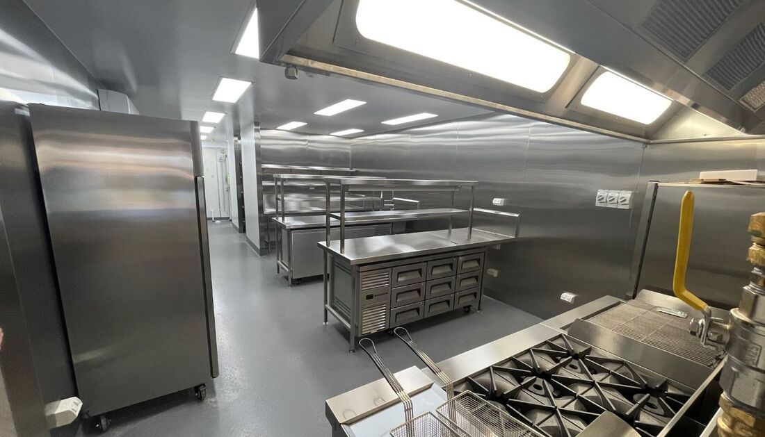 A Kitchen with A Lot of Stainless Steel Appliances and A Stove — Townsville Stainless Steel in Garbutt, QLD