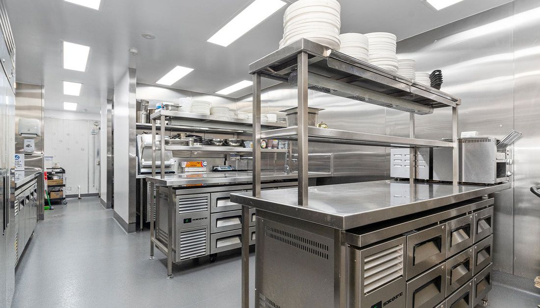 A Kitchen with A Lot of Stainless Steel Appliances and Shelves — Townsville Stainless Steel in Garbutt, QLD