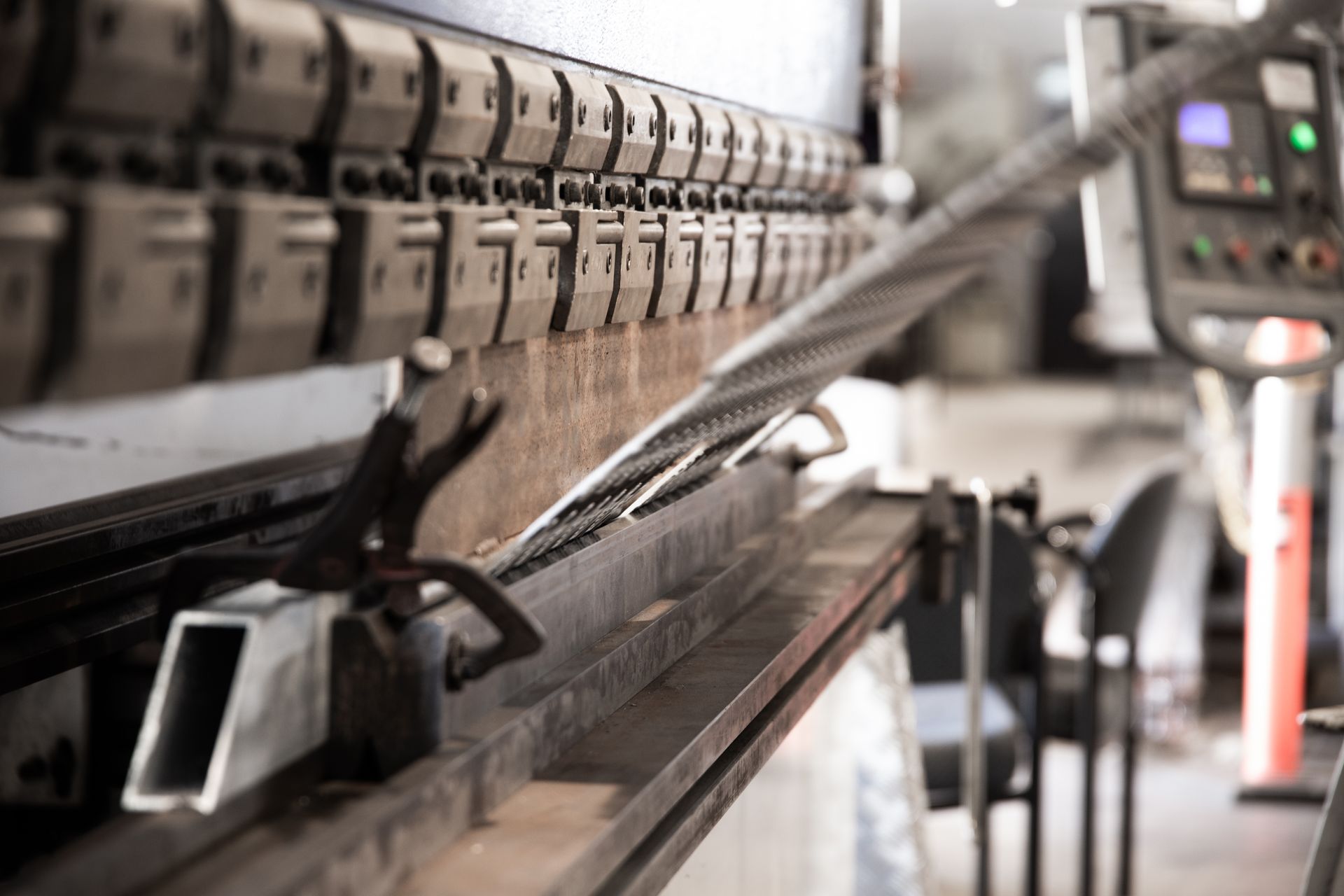 A Metal Press Brake in a Workshop, Bending a Metal Sheet — Townsville Stainless Steel in Garbutt, QLD