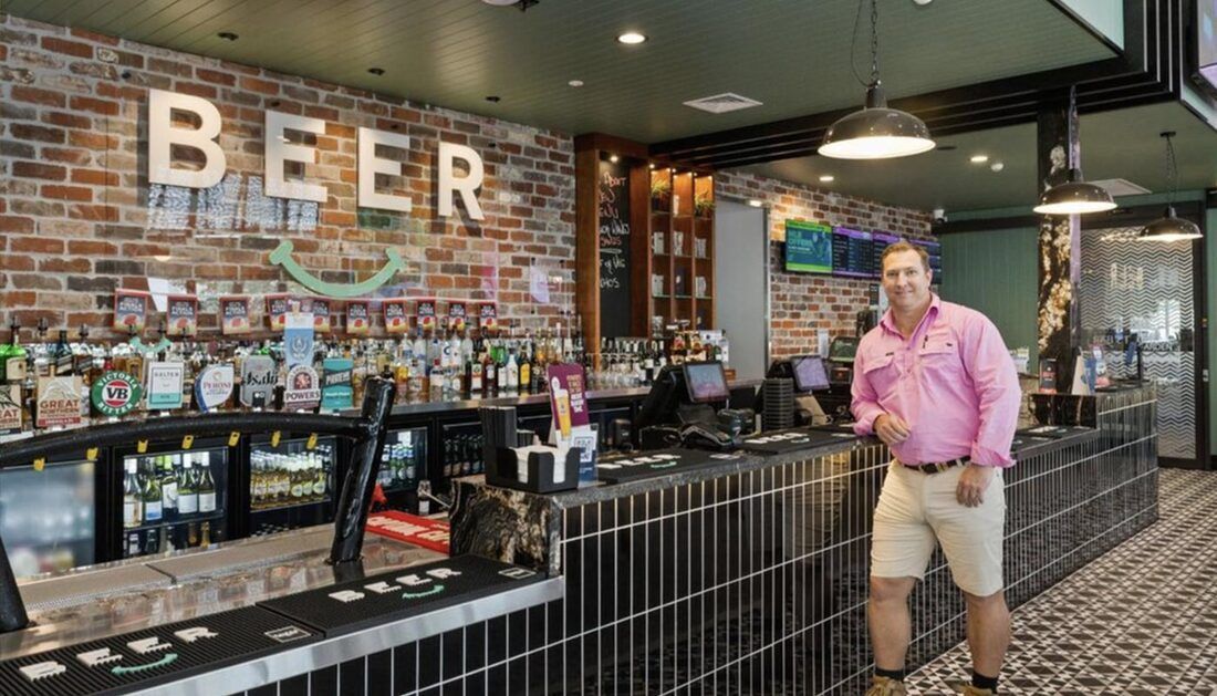 A Man Is Standing in Front of A Bar in A Restaurant — Townsville Stainless Steel in Garbutt, QLD