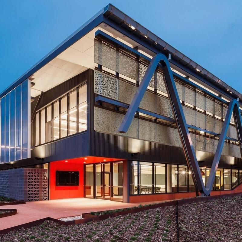 A Large Building with A Lot of Windows and A Red Door — Townsville Stainless Steel in Garbutt, QLD