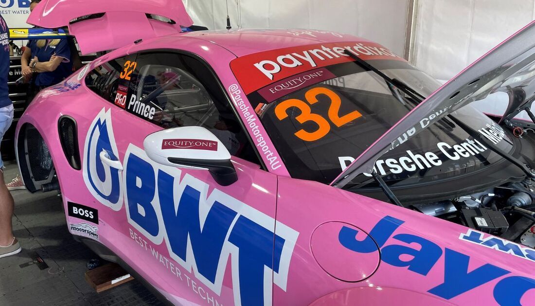 A Pink Race Car with The Number 32 on It Is Parked in A Garage  — Townsville Stainless Steel in Garbutt, QLD