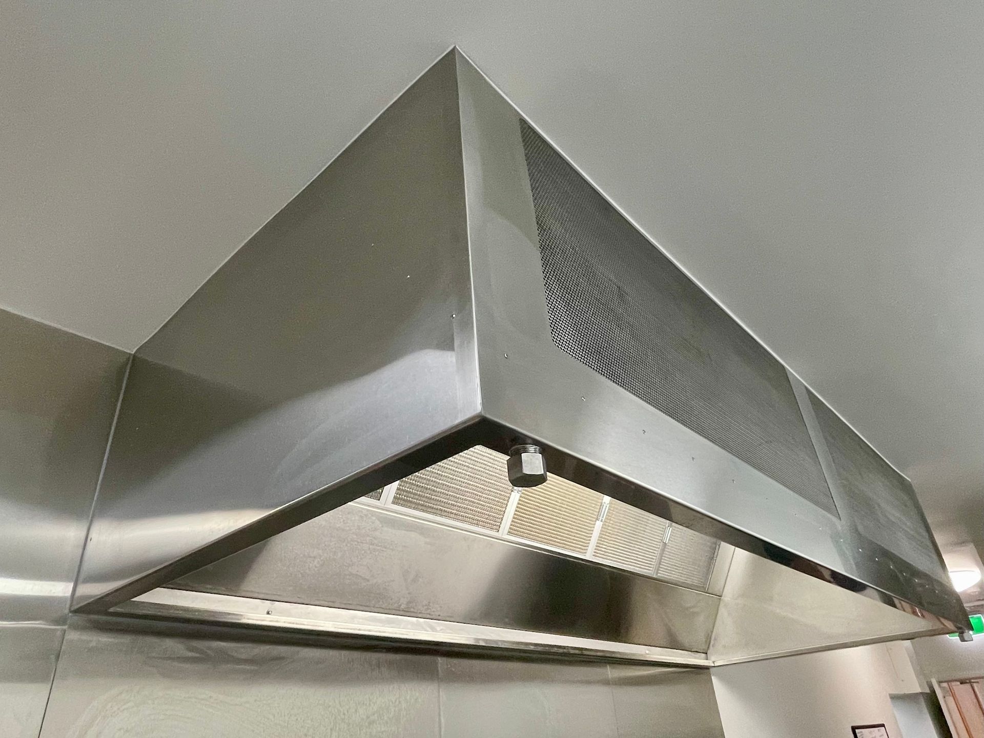 Stainless Steel Commercial Kitchen Exhaust Hood Mounted on a Wall — Townsville Stainless Steel in Garbutt, QLD