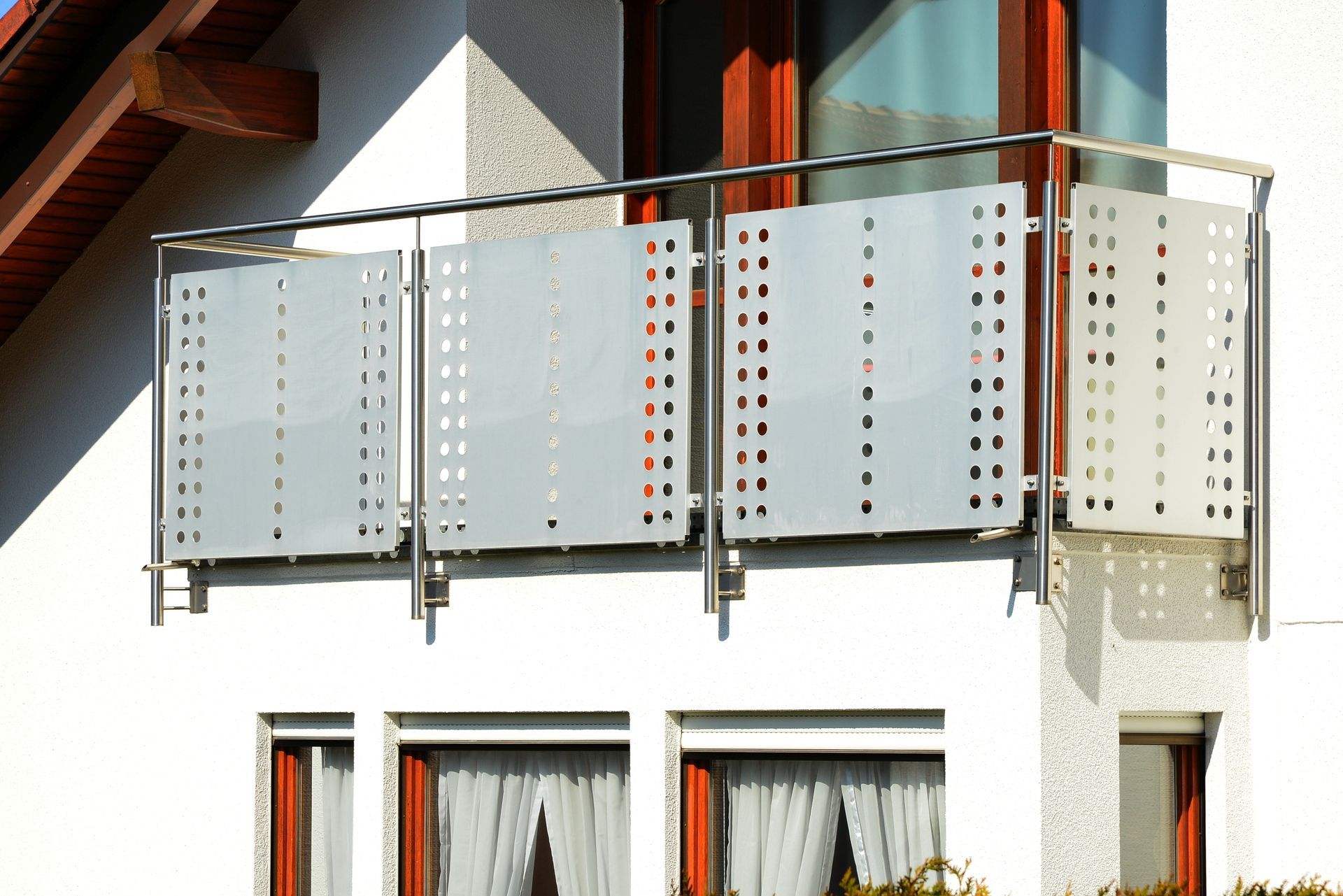 A Man in A Yellow Shirt Is Cutting a Piece of Metal with A Pair of Scissors — Townsville Stainless Steel in Garbutt, QLD