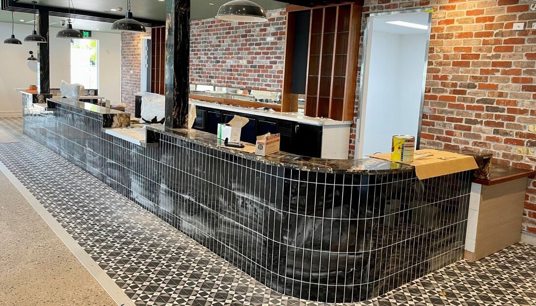 A Long Counter in A Restaurant with A Brick Wall — Townsville Stainless Steel in Garbutt, QLD
