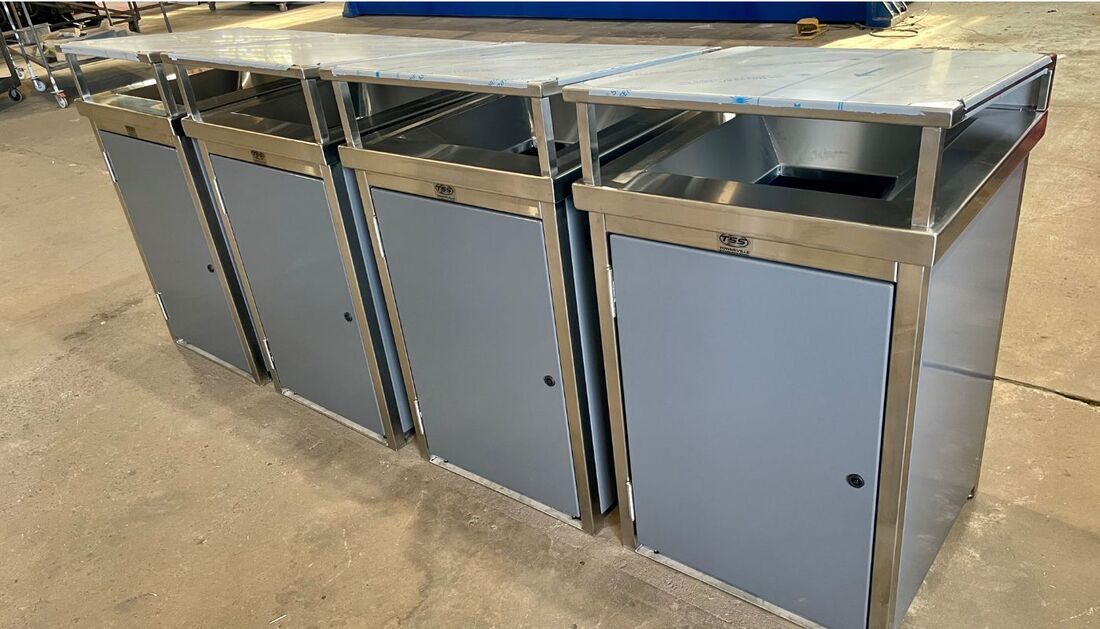 A Row of Stainless Steel Trash Cans Sitting on Top of A Table  — Townsville Stainless Steel in Garbutt, QLD