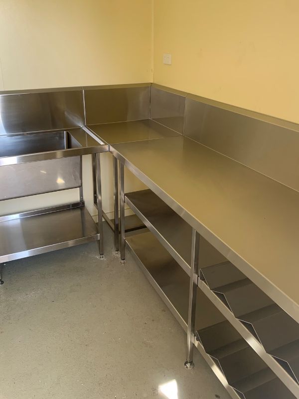 A Kitchen with Stainless Steel Counter Tops and Shelves  — Townsville Stainless Steel in Garbutt, QLD