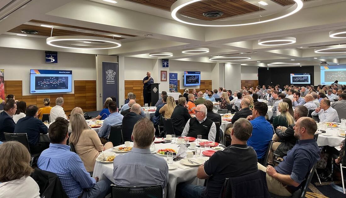 A Large Group of People Are Sitting at Tables in A Large Room — Townsville Stainless Steel in Garbutt, QLD