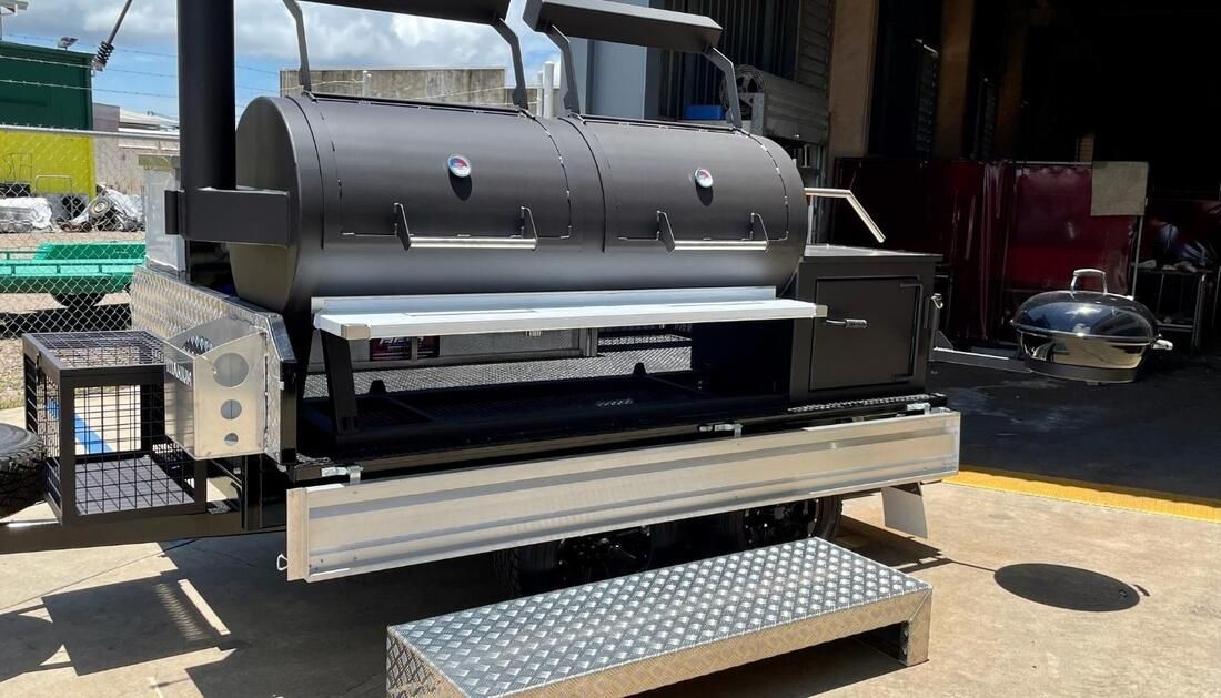 A Large Grill Is Sitting on Top of A Trailer in A Garage — Townsville Stainless Steel in Garbutt, QLD