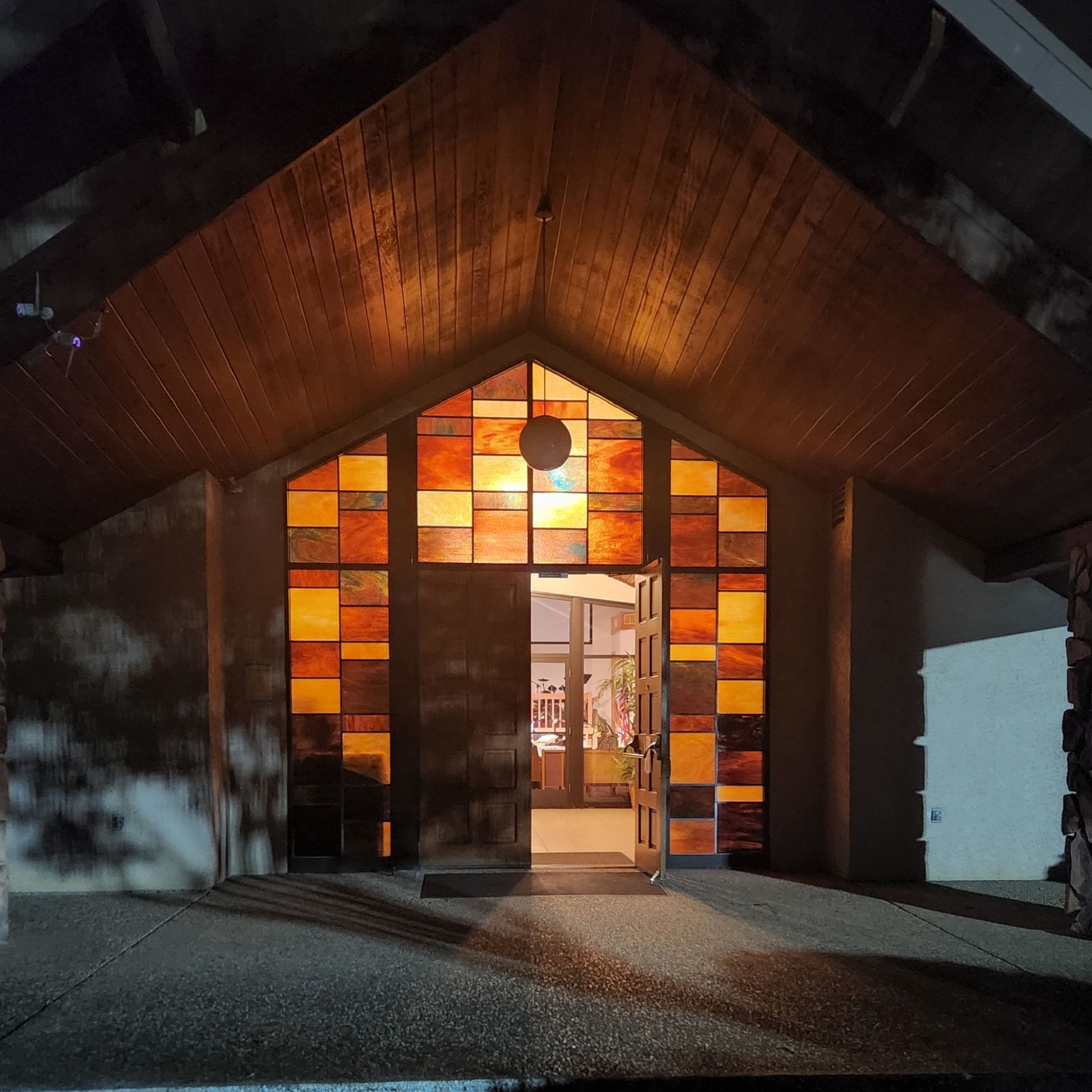 picture of the front of the church at night, light backlit glow