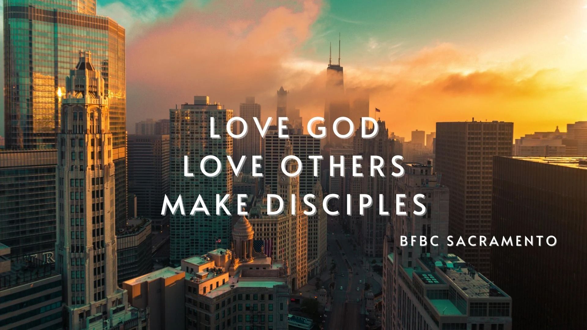 An aerial view of a city with a quote that says "love God, love others, make disciples".