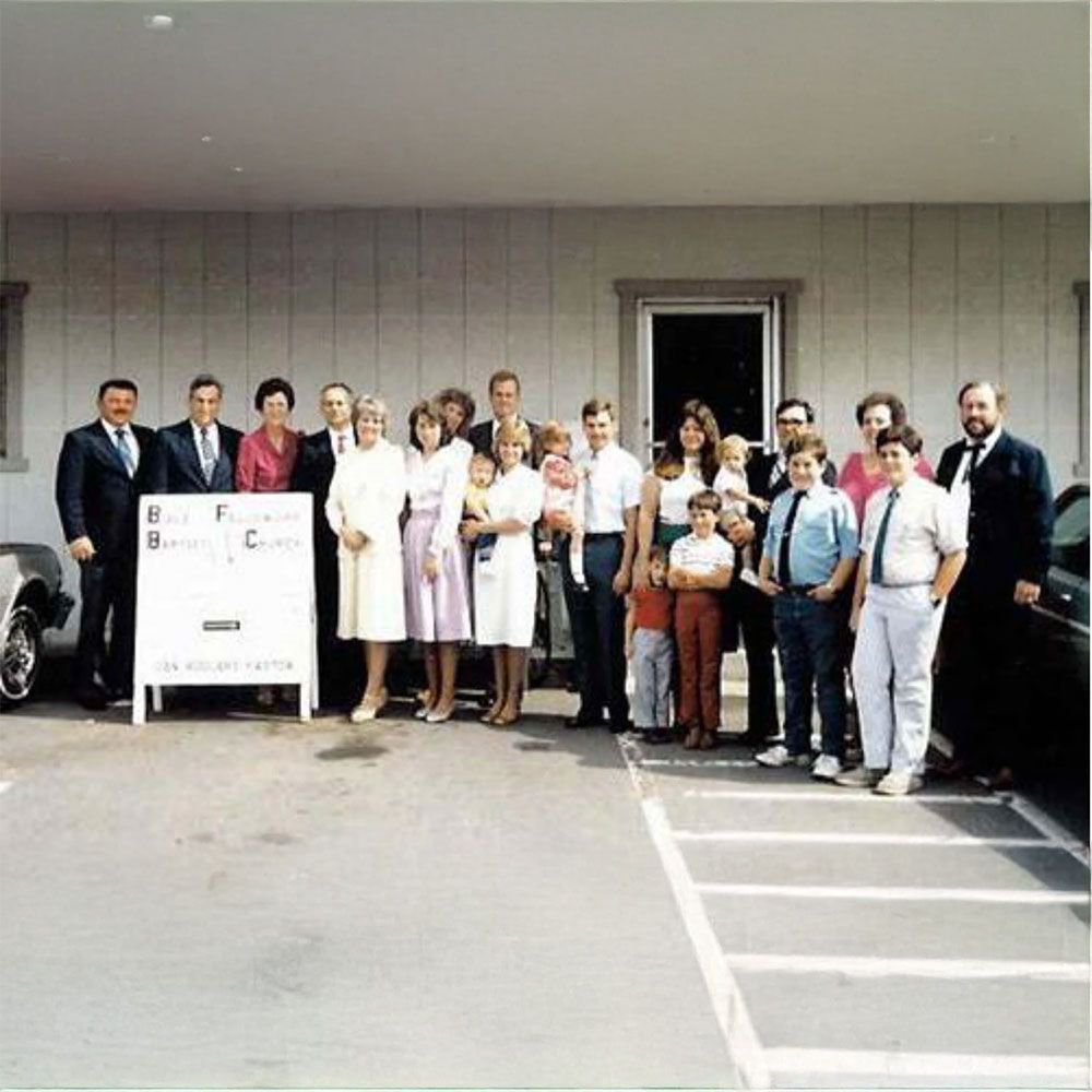 A large group of people standing in front of a building