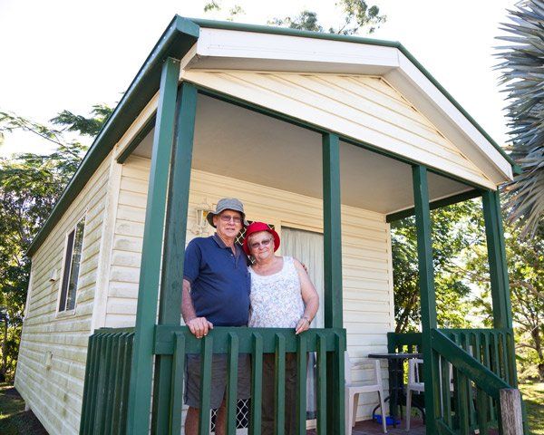 Mobile Home Financing — Seniors Couple in Front of Holiday Cabin in Allentown, PA