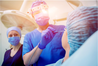 A surgeon holding a nasal endoscope.