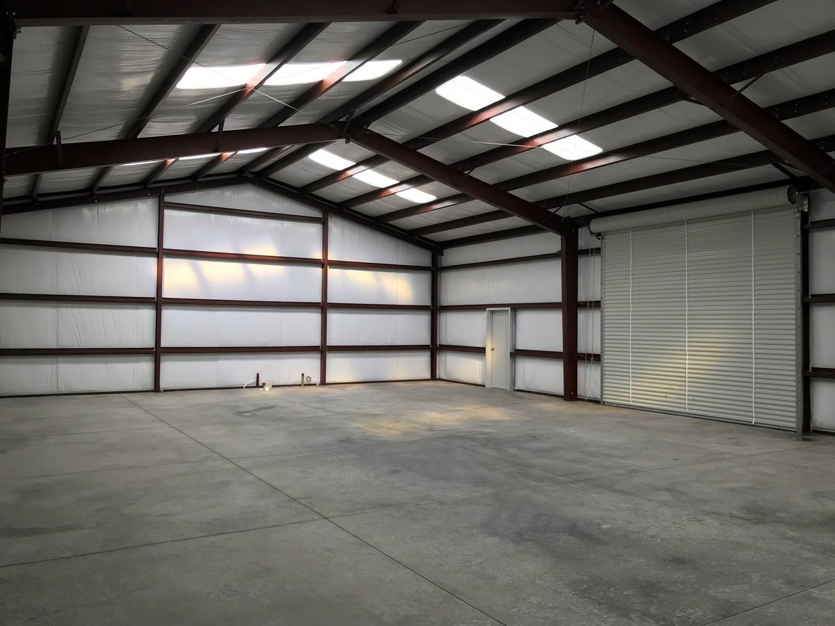 A large empty warehouse with a concrete floor