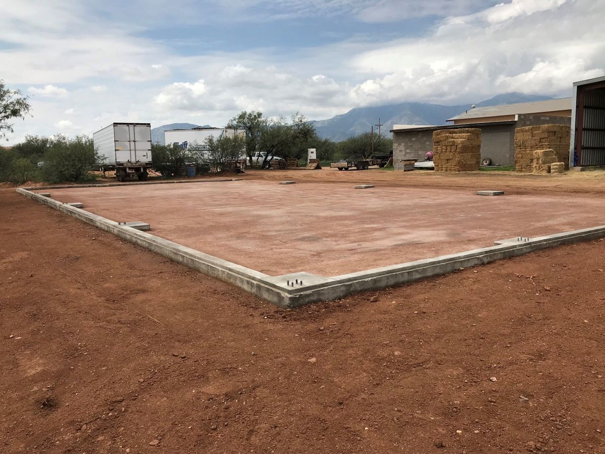A large dirt field with a truck in the background.