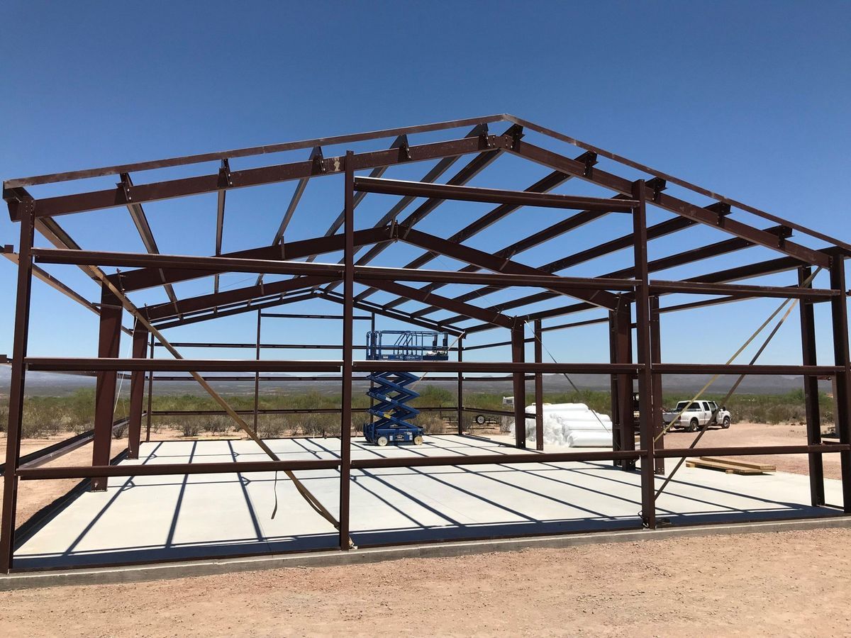 A large metal structure is being built in the desert