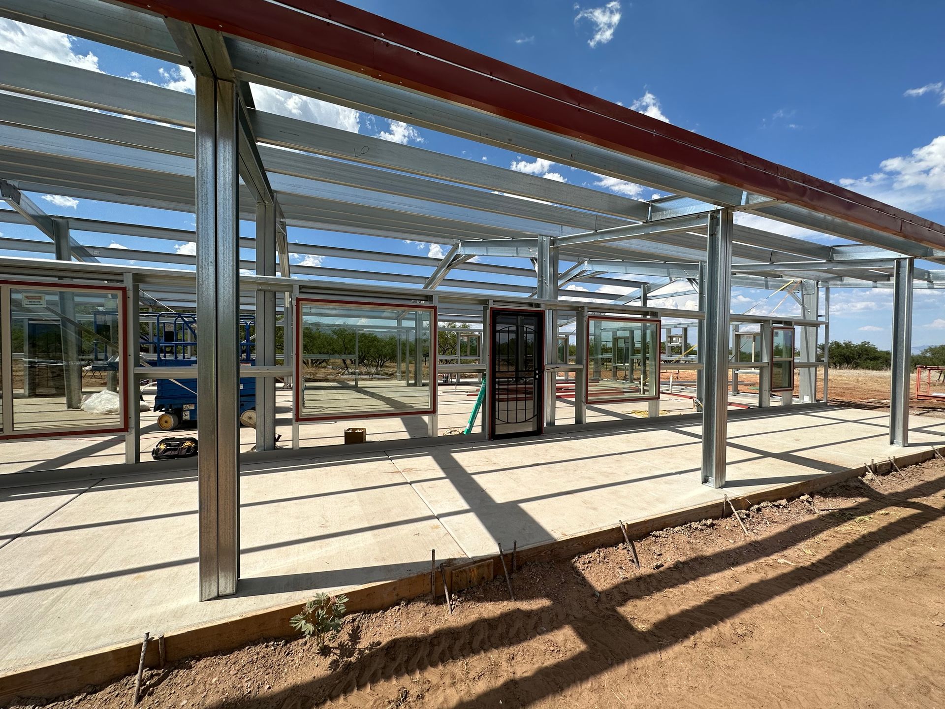 A large metal structure is being built in the desert.