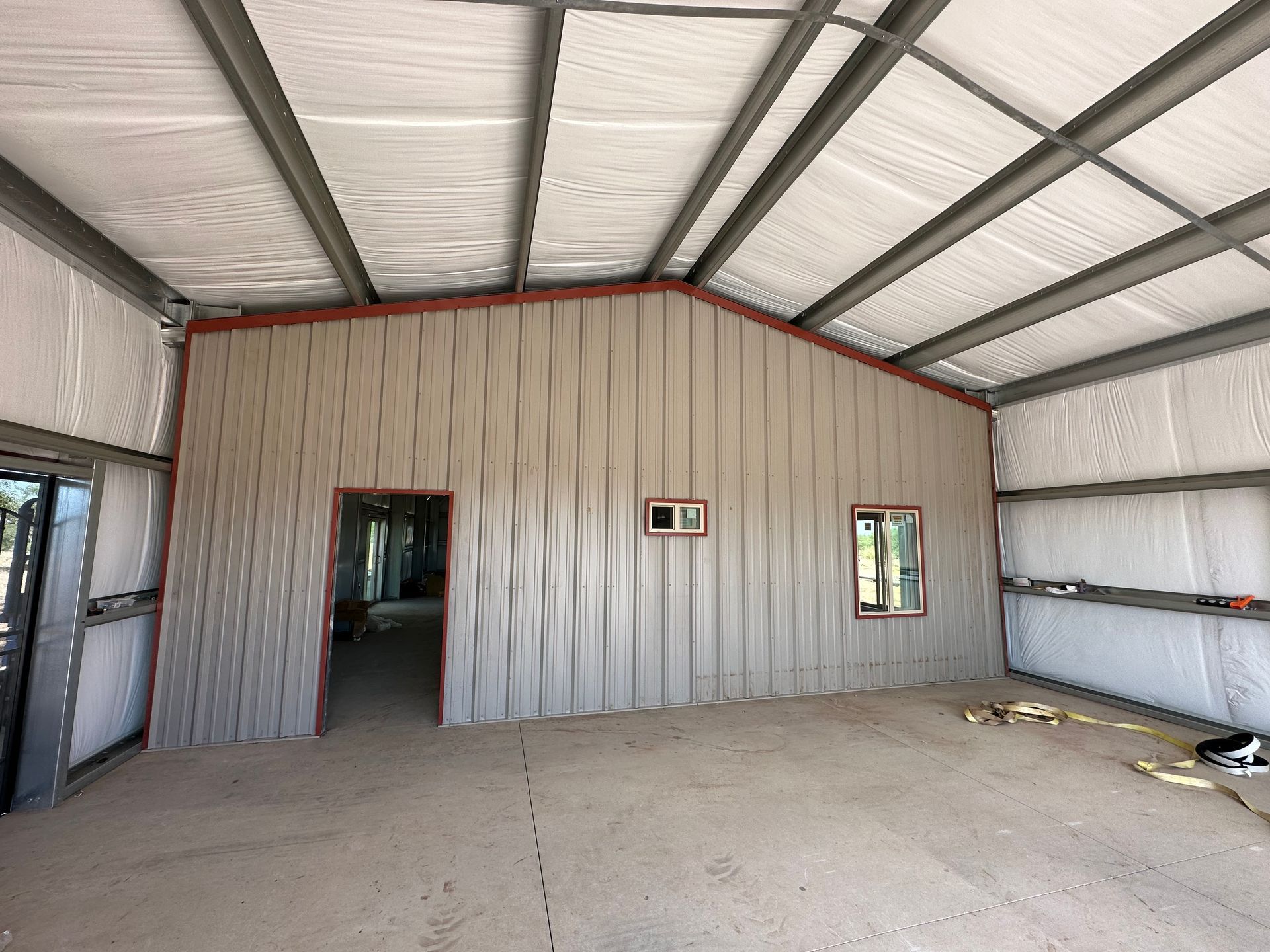 A large empty room with a metal roof and walls.