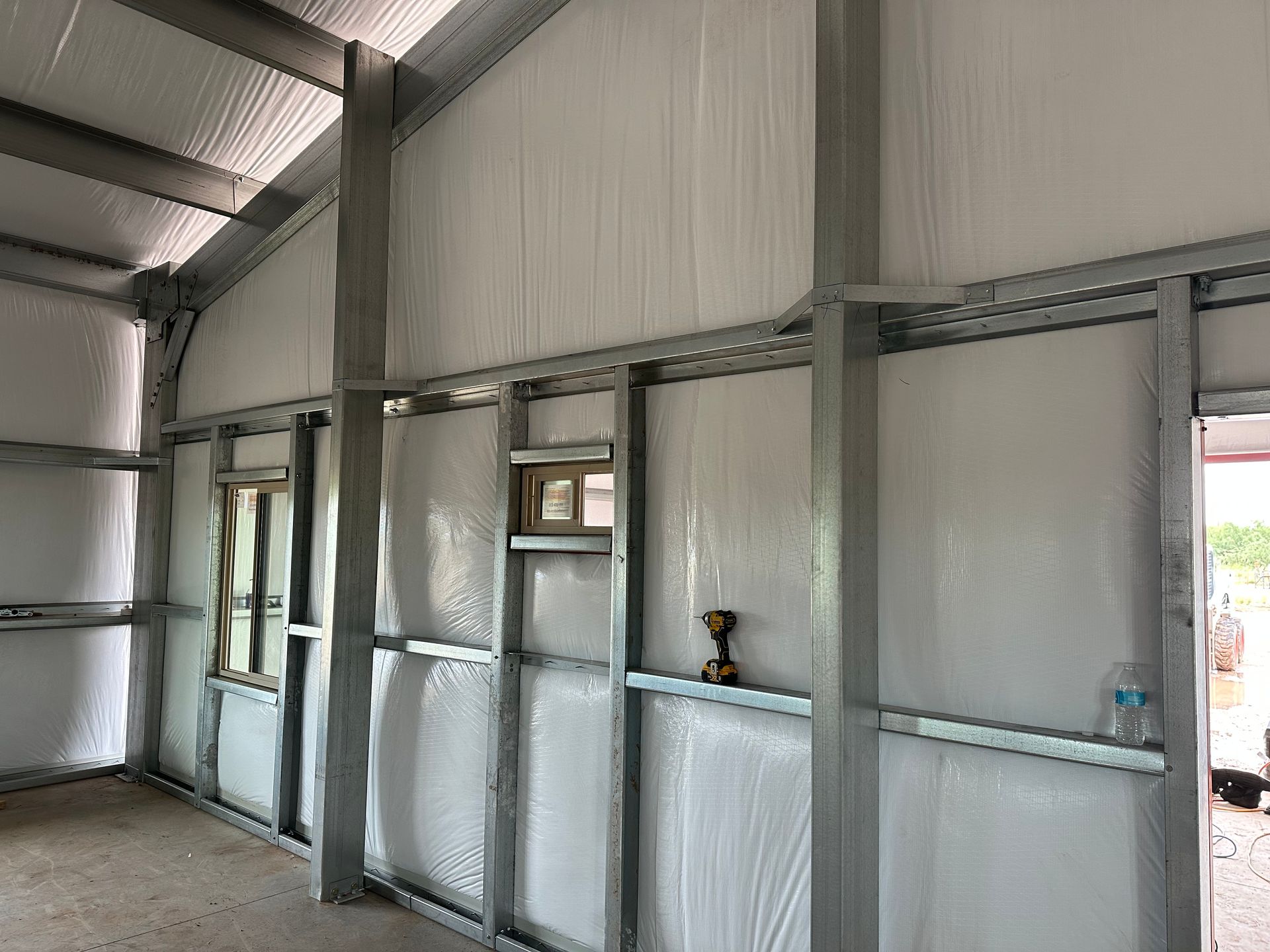 The inside of a building with a drill on the wall.