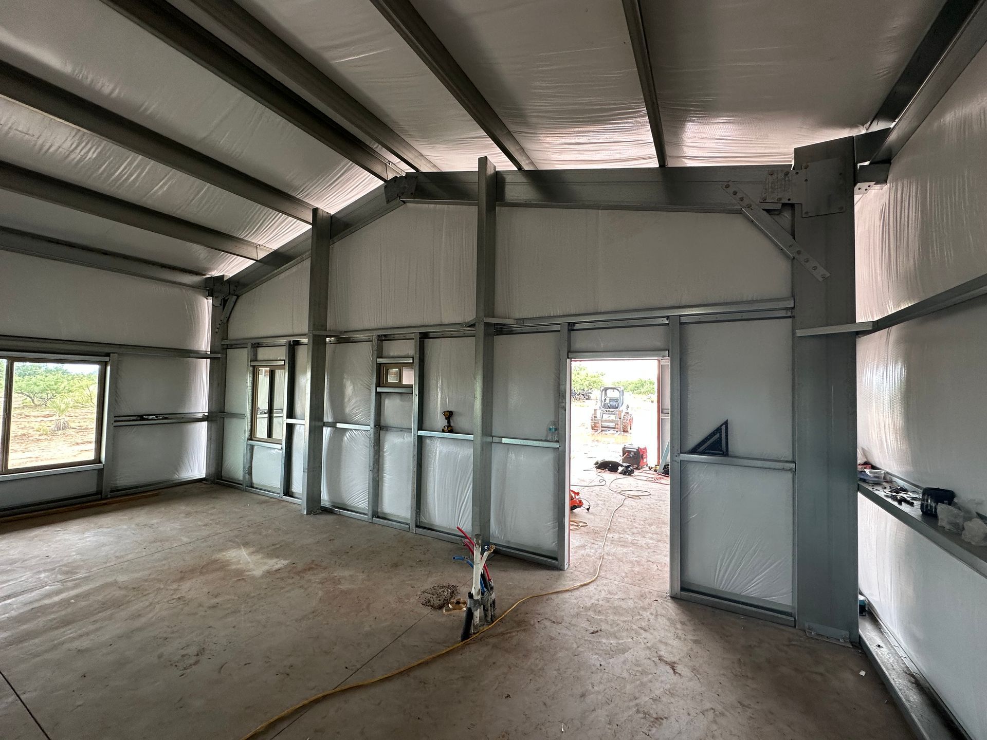 A large empty building with a lot of windows and doors.