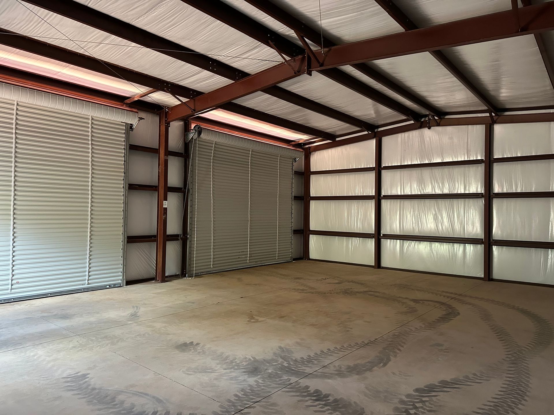 A large empty garage with a large garage door