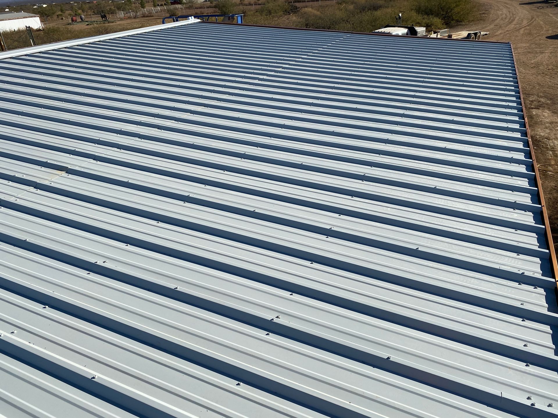 An aerial view of a metal roof of a building